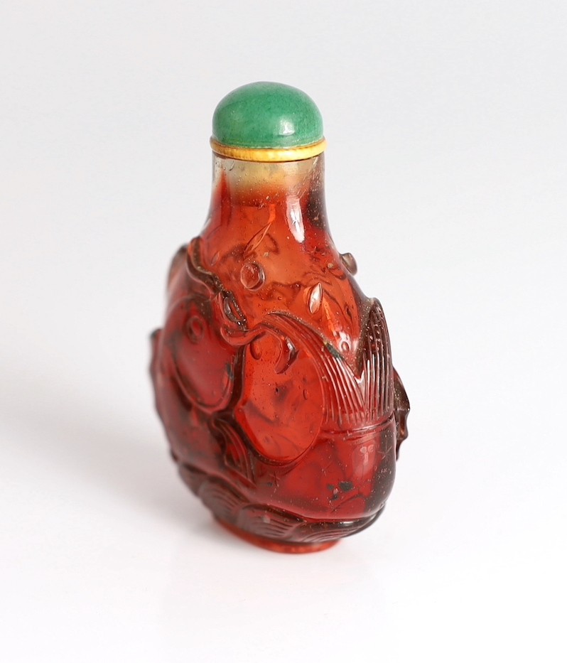 A Chinese ruby red glass ‘leaping carp’ snuff bottle, 1750-1850, 5.9cm high